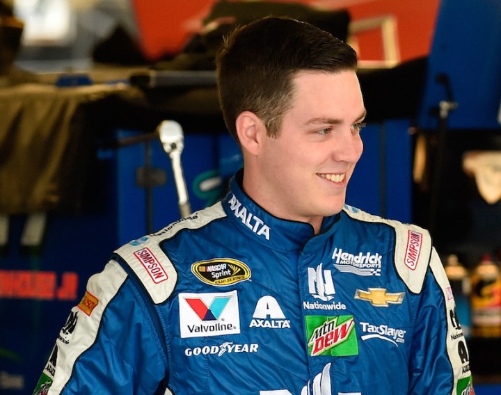KANSAS CITY, KS - OCTOBER 14: Alex Bowman, driver of the #88 Nationwide Chevrolet, stands in the garage area during practice for the NASCAR Sprint Cup Series Hollywood Casino 400 at Kansas Speedway on October 14, 2016 in Kansas City, Kansas. (Photo by Jason Hanna/Getty Images)